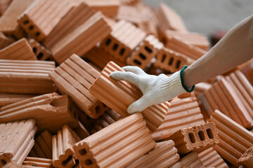 Close up view male bricklayer working on construction site. Concept of repair and building materials