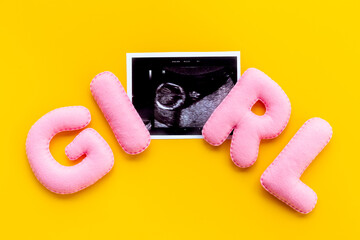 Ultrasound scan of unborn baby with letters girl