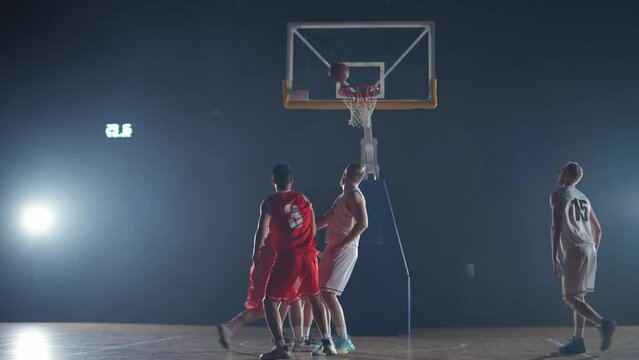 International basketball game, the confrontation between two teams, sporty lifestyle, mens active game at night time, cinematic light.