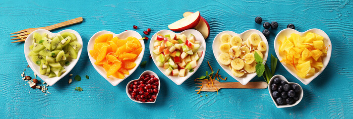 Various fruits on turquoise background.