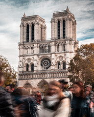 View of Notre Dame cathedral amidst the daily hustle and bustle of Paris.