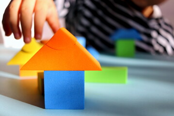 children's multi-colored geometric shapes close-up on a blue background selective focus and blurred...