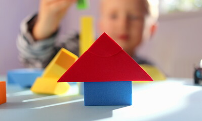 children's multi-colored geometric shapes close-up on a blue background selective focus and blurred...