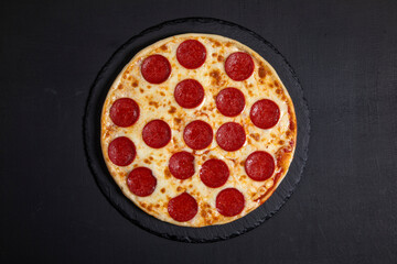 Pepperoni pizza on dark background