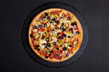 Mixed pizza on dark background