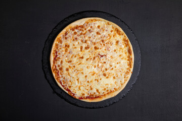 Tasty vegetarian pizza on dark background