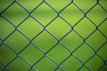 Fototapeta premium Fence net. Fence on green background.