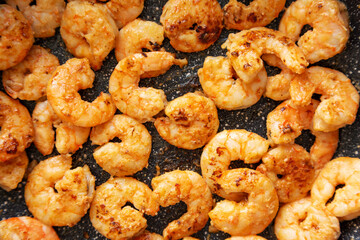 Cooking shrimps on a frypan, top view. Close-up.