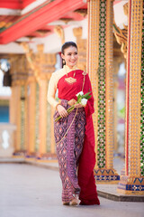 Fototapeta na wymiar Beautiful Thai girl in traditional dress costume in Thailand temple show Jasmine garland with smiling