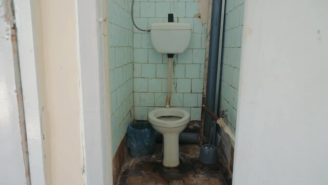 an old abandoned toilet and a toilet room in need of major repairs. Toilet used in the Russian Federation