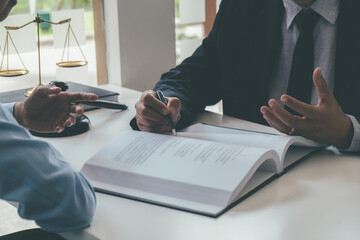 Judge gavel with Justice lawyers having team meeting at law firm background. Concepts of Law and Legal services.