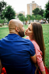 Couple lovers hugging and kissing in the park at sunset. Love, happiness concept.