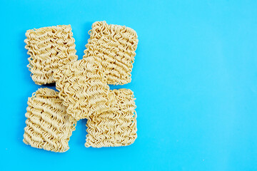 Dried instant noodles on blue background.