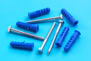Steel screws on blue background.