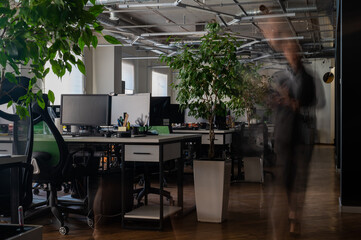 Blurred female figure in motion in the office.