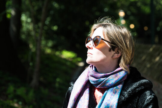 Attractive Thirty Year Old Woman Posing In The Sun, In A Brussels Citypark During Spring