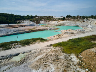 Aerial view quarry extraction porcelain clay, kaolin, with turquoise water