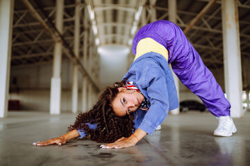 Beautiful sportive girl dancing  in stylish clothes in the underpass. Sport, dancing and urban...
