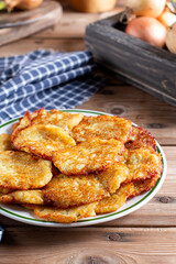 Potato pancakes or latkes on a wooden background