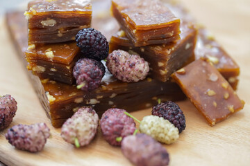 Made with mulberry fruit , jam , molasses and fruit pulp .