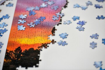 Puzzles for the picture lie on a white table.