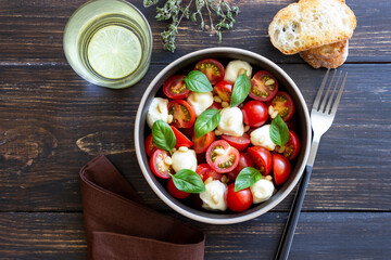 Salad with mozzarella, tomatoes, nuts and basil. Healthy eating. Vegetarian food. Diet.