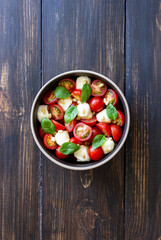 Salad with mozzarella, tomatoes, nuts and basil. Healthy eating. Vegetarian food. Diet.