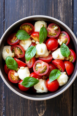 Salad with mozzarella, tomatoes, nuts and basil. Healthy eating. Vegetarian food. Diet.