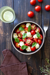 Salad with mozzarella, tomatoes, nuts and basil. Healthy eating. Vegetarian food. Diet.