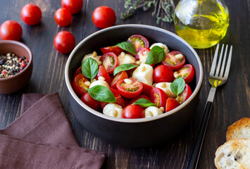 Salad with mozzarella, tomatoes, nuts and basil. Healthy eating. Vegetarian food. Diet.