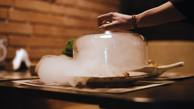 waitress opening the bowl full of smoke with meal (super slow-motion)
