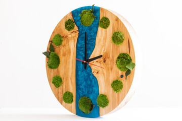 round clock made of natural wood and epoxy resin with sterilized moss