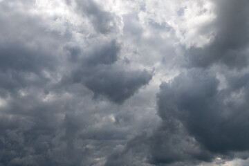 Cloud formations on stormy blue evening sky in Göttingen Germany with shades of blue and grey. Summer sunlight after heavy rain shower, conditions. Weather background with high contrast dark blue.