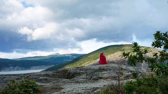 Mountain women sits on the rocks, Chile, Patagonia region, Trekking girl have a rest.