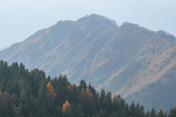 Val Seriana, its peaks, woods and autumnal landscape during an October afternoon, near the town of...
