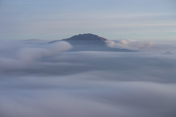 The Orobie Alps at sunset, shrouded in clouds, during an autumn evening, near the town of Castione della presolana, Italy - October 2021.