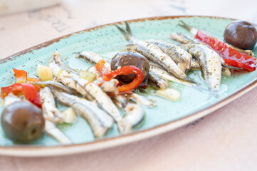Anchovies marinated in olive oil with olives