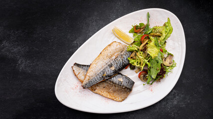 Two baked mackerel fillets on a plate