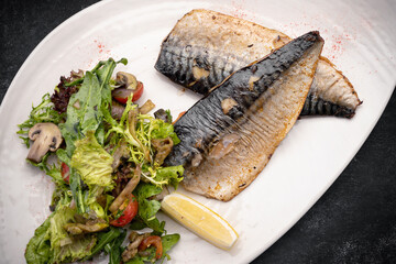 Two baked mackerel fillets on a plate