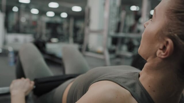 Young caucasian woman  doing hip thrust exercise  hip at a gym. Shot with RED helium camera in 8K. 