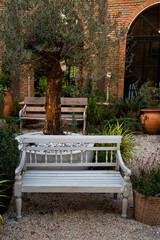 white bench in the garden to relax