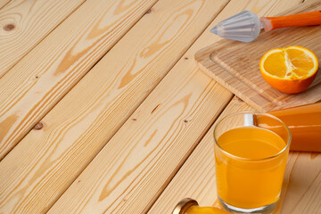 Glass of fresh orange juice with fresh fruits on wooden table