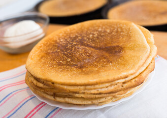 cooking traditional pancakes from wheat flour in the kitchen