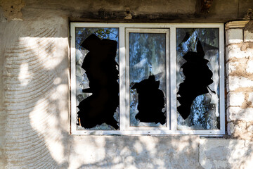 Broken window of residential home in close-up. Broken glass window outside - obrazy, fototapety, plakaty