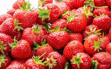 Ripe strawberries with green sepals. Background