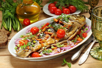 Fried carp with vegetables on a white background
