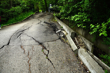 Asphalt road destroyed by the landslide