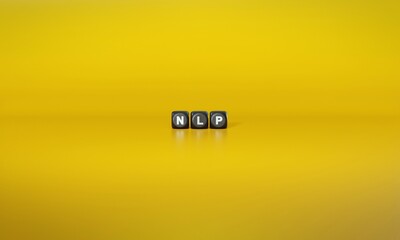 Acronym ‘NLP’ or ‘Neuro-linguistic Programming’ spelled out in white text on dark wooden blocks against plain yellow background. 3D rendering