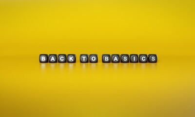 Words ‘Back to basics’ spelled out in white text on dark wooden blocks against plain yellow background. 3D rendering