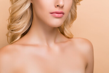 Fototapeta premium Cropped view portrait of attractive groomed wavy-haired woman laser peeling effect isolated over beige pastel color background